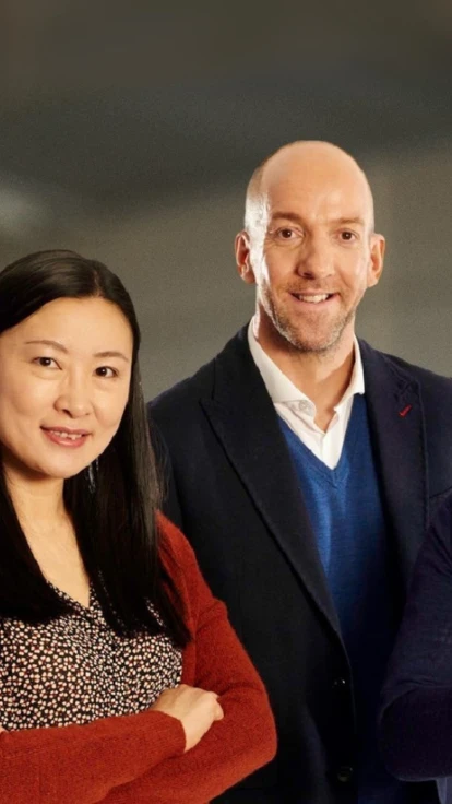 Three teachers standing in a classroom