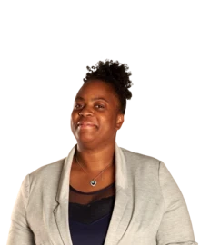 A teacher smiles to camera.