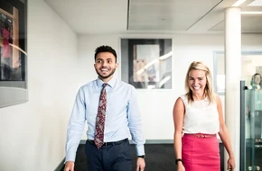Image of two teachers walking through school halls smiling
