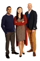 Three volunteers looking towards the camera.